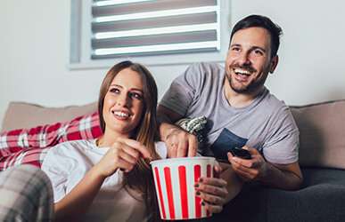 woman and man looking at tv