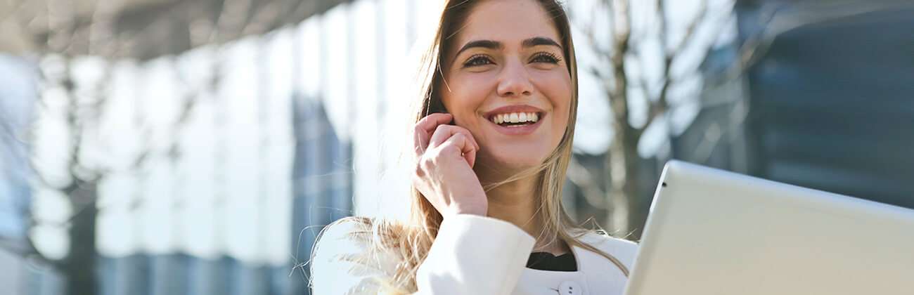 Business woman on phone outside an office building