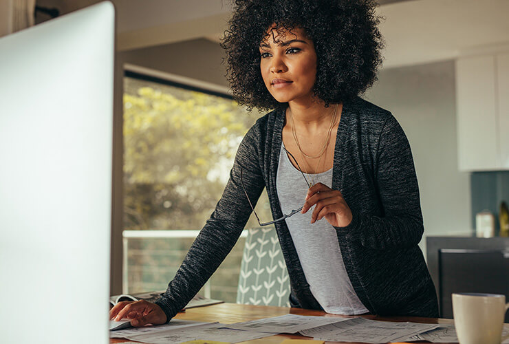 Woman standing up at her desktop