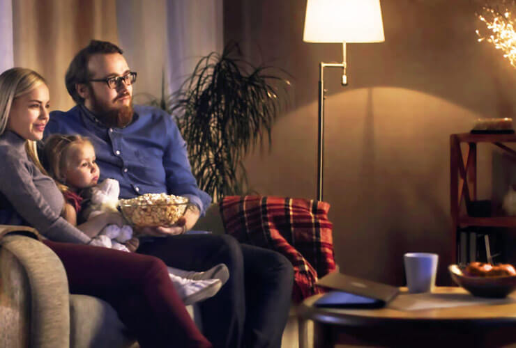 young family on the sofa watches streaming TV